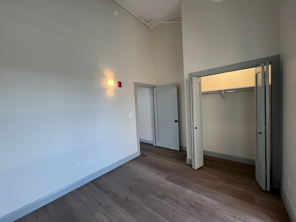 160 Seabury Street, Unit 29 Fall River, MA 02720 - Photo 13 of 17 an empty room with wooden floor and windows