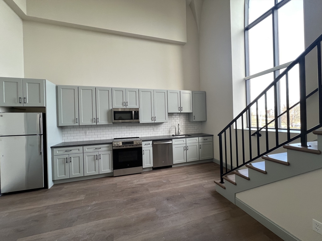 160 Seabury Street, Unit 29 Fall River, MA 02720 - Photo 2 of 17 a kitchen with stainless steel appliances granite countertop a stove a sink and a refrigerator