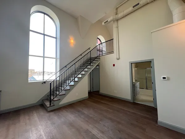 a view of entryway with wooden floor and stairs