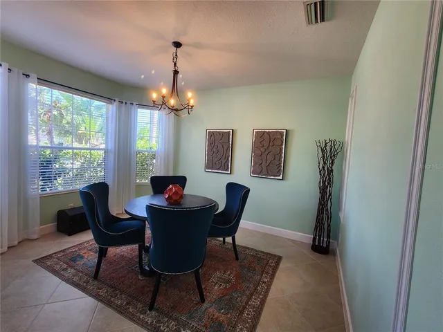 a dining room with furniture and window