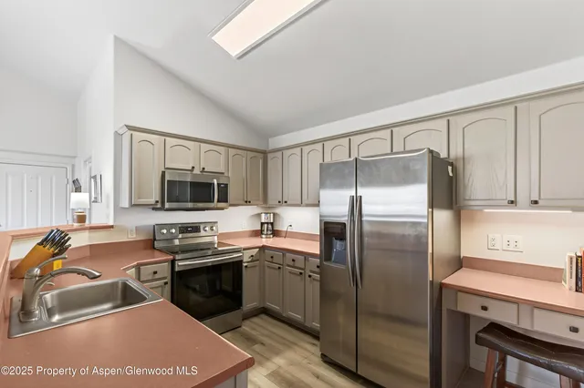 a kitchen with a sink appliances and cabinets