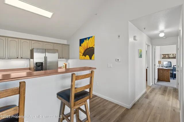 a kitchen with stainless steel appliances granite countertop a refrigerator and a stove top oven