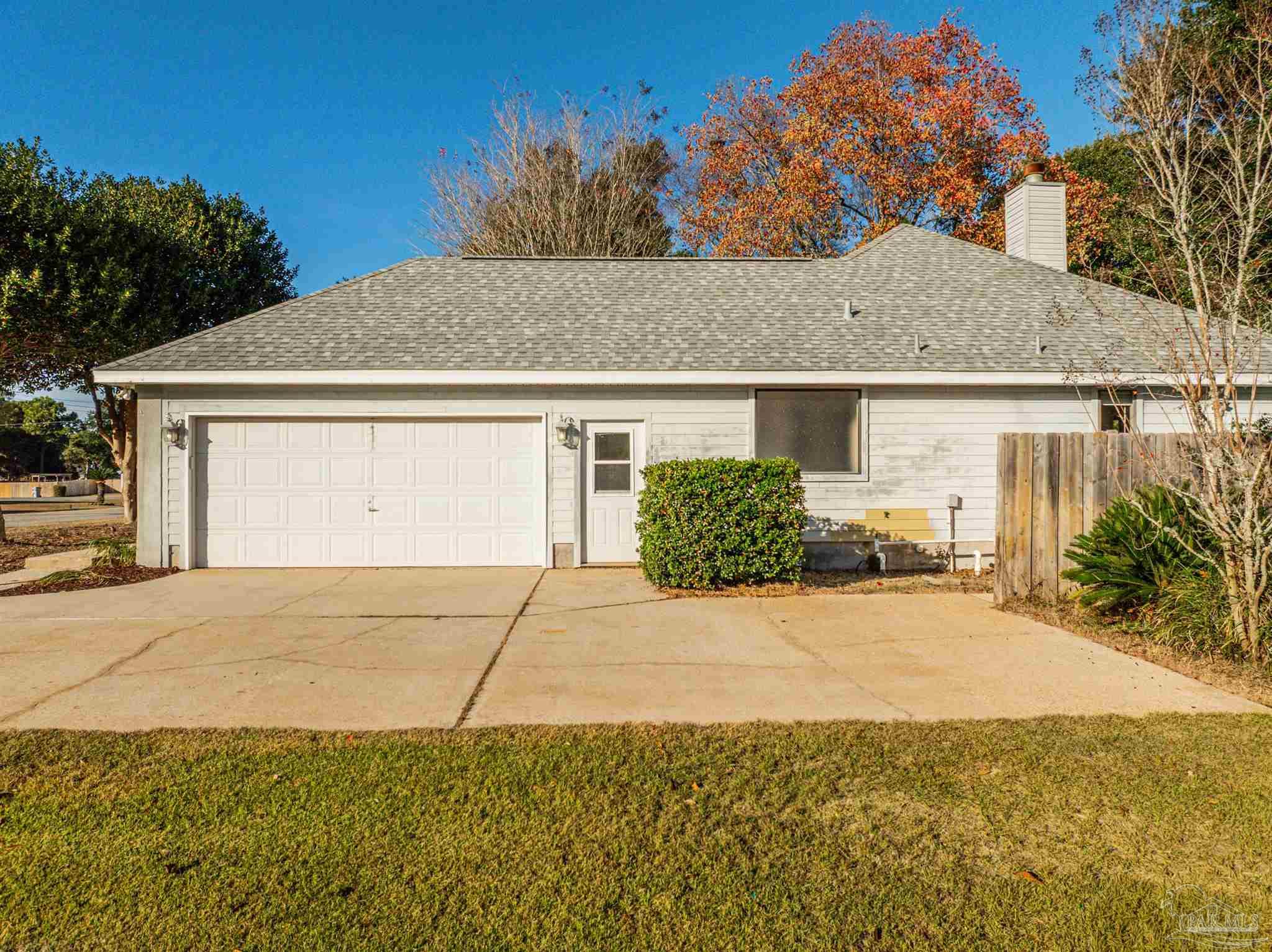 1860 Sparrow Lane Navarre, FL 32566 - Photo 16 of 43 a front view of a house with a yard and garage