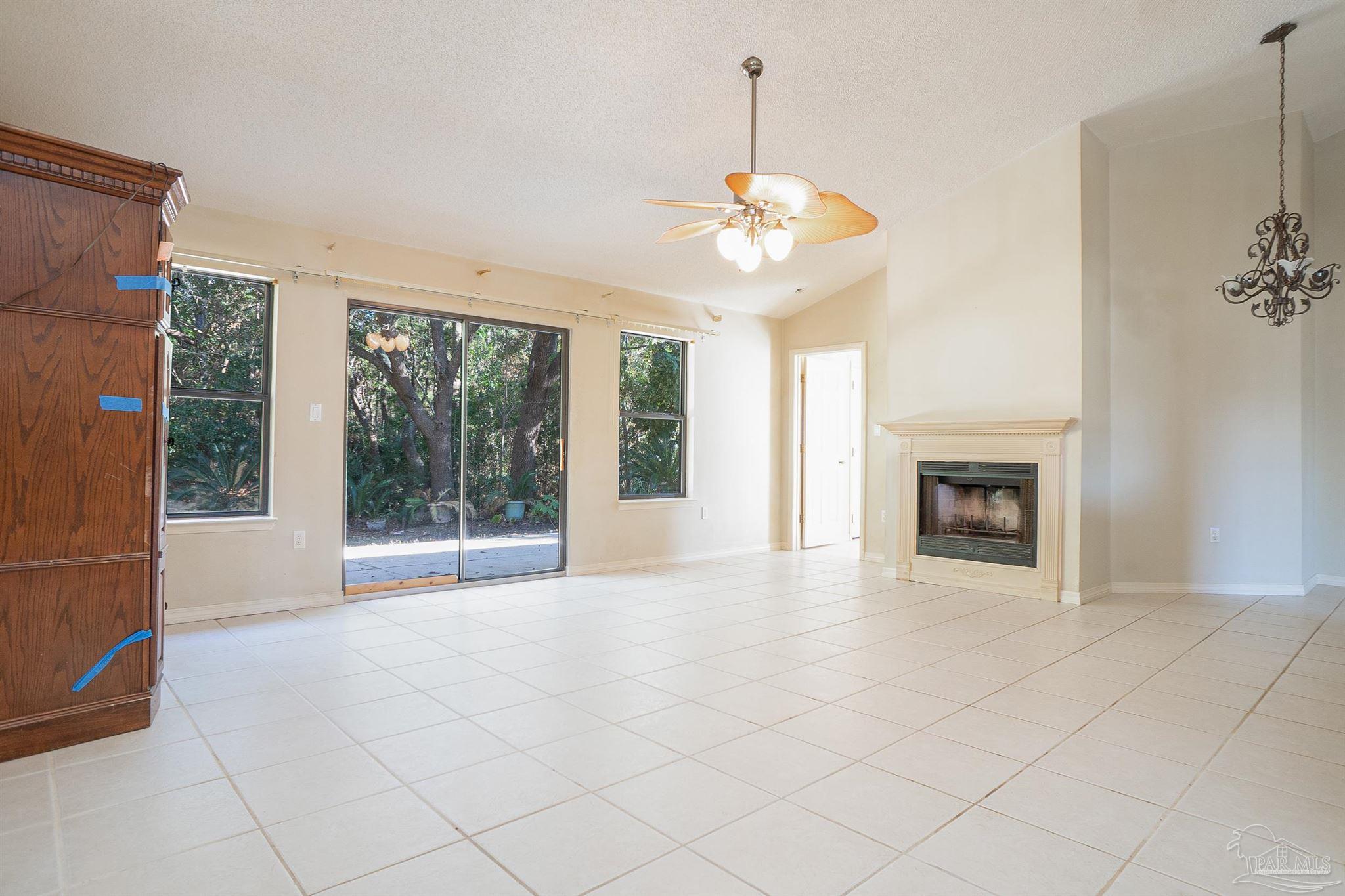 1860 Sparrow Lane Navarre, FL 32566 - Photo 17 of 43 a view of an empty room with a fireplace and a window