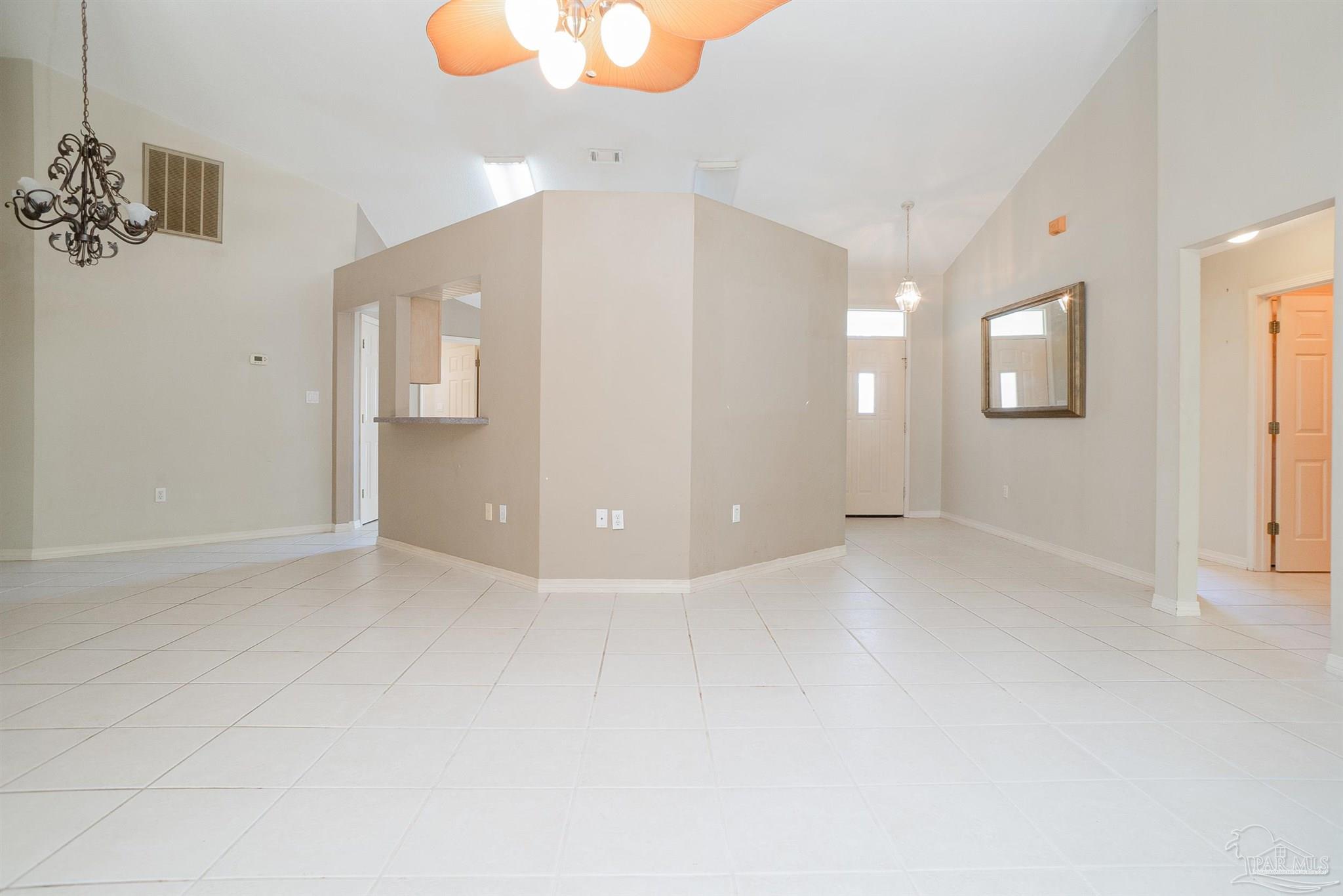 1860 Sparrow Lane Navarre, FL 32566 - Photo 19 of 43 en empty room with windows and chandelier