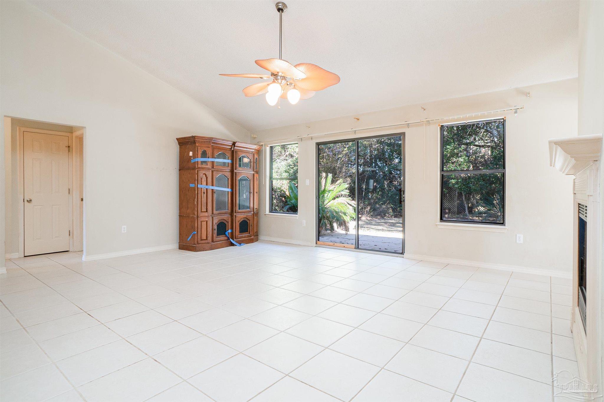 1860 Sparrow Lane Navarre, FL 32566 - Photo 22 of 43 an empty room with chandelier fan and windows