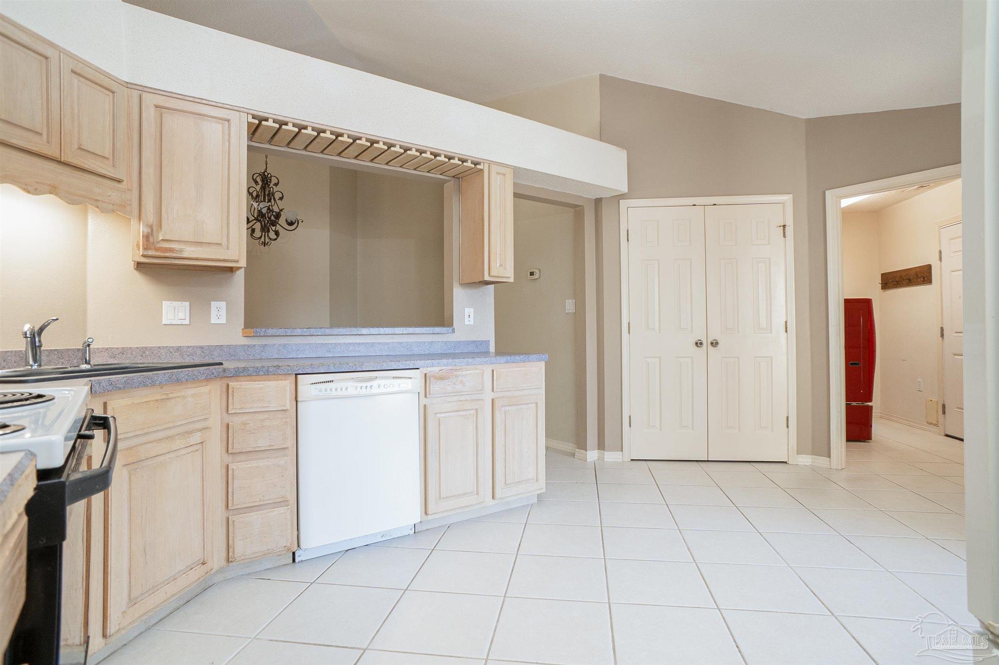 1860 Sparrow Lane Navarre, FL 32566 - Photo 24 of 43 a view of a kitchen with white cabinets