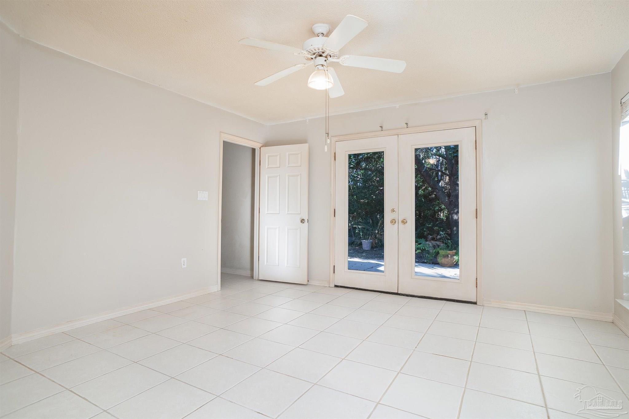 1860 Sparrow Lane Navarre, FL 32566 - Photo 30 of 43 an empty room with chandelier fan and windows