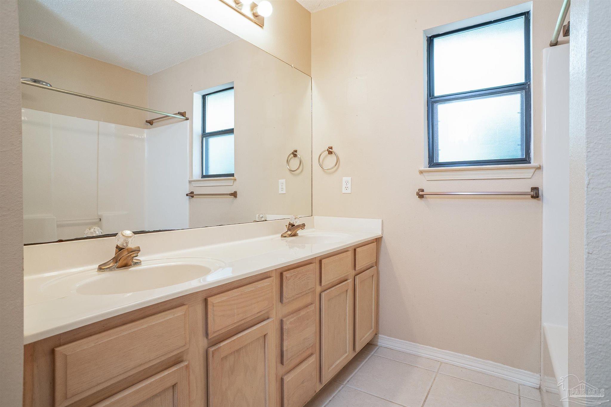1860 Sparrow Lane Navarre, FL 32566 - Photo 37 of 43 a bathroom with a sink and a mirror