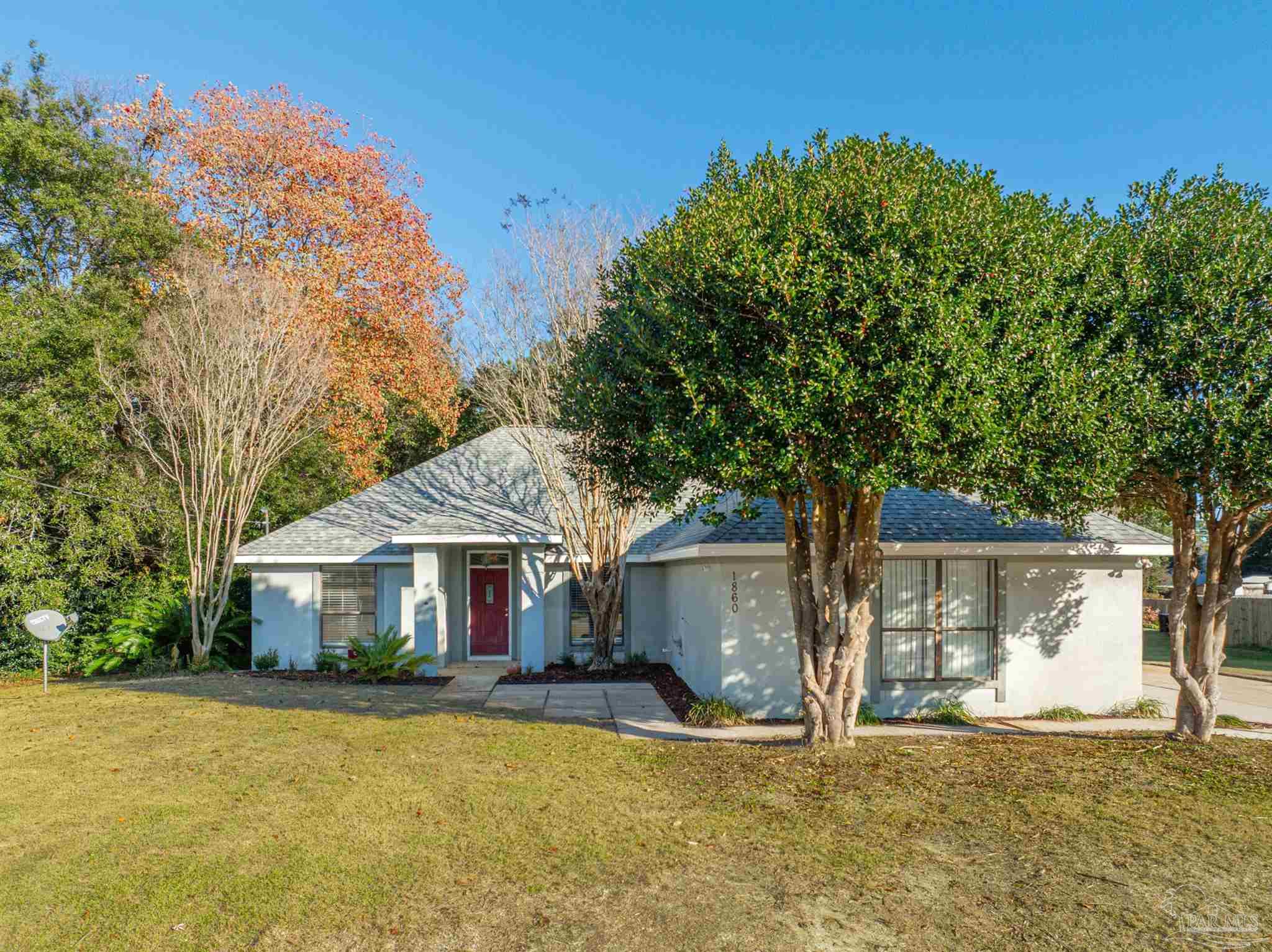 1860 Sparrow Lane Navarre, FL 32566 - Photo 4 of 43 a front view of a house with a yard