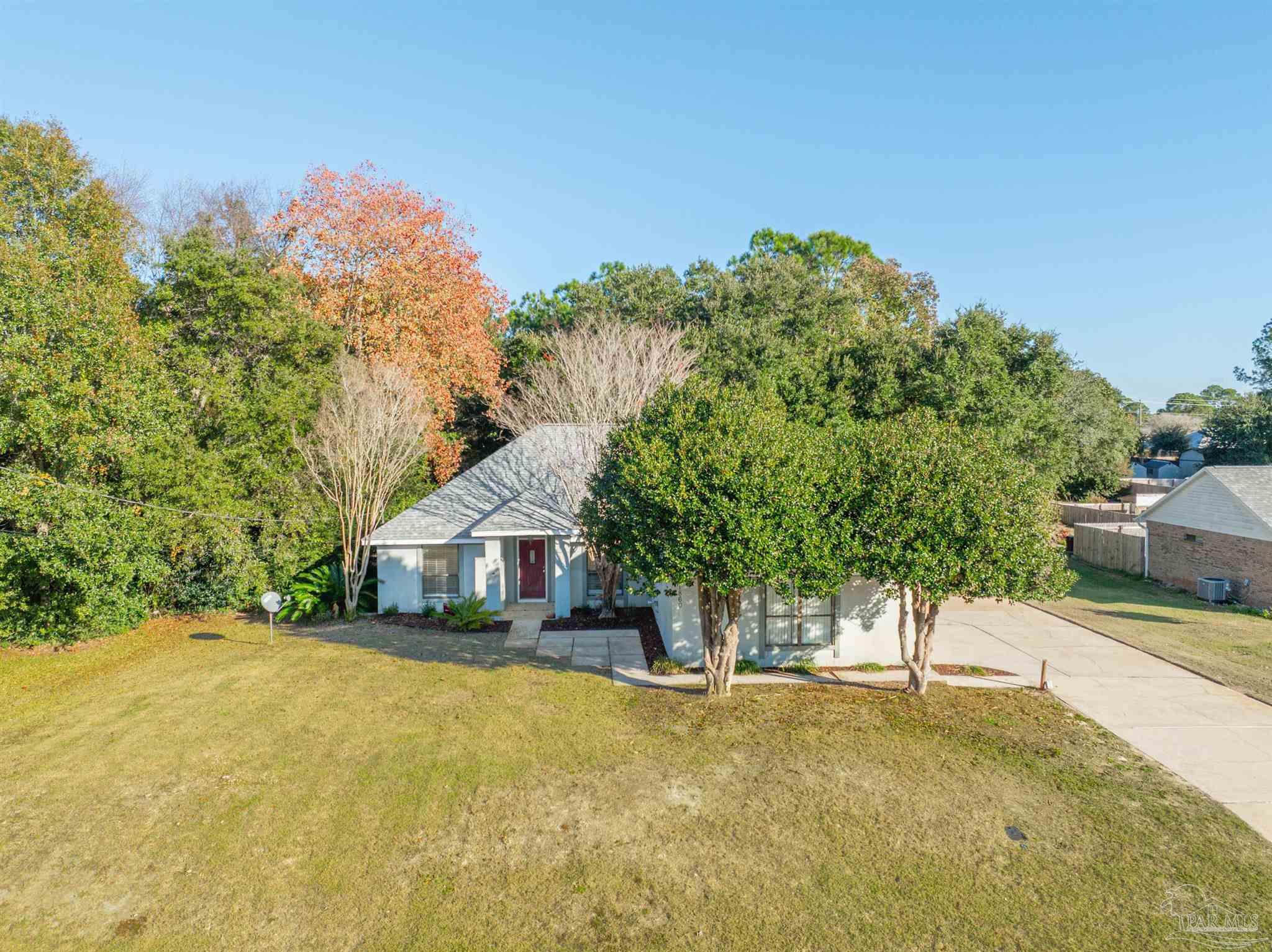 1860 Sparrow Lane Navarre, FL 32566 - Photo 6 of 43 a view of house with outdoor space and trees in the background