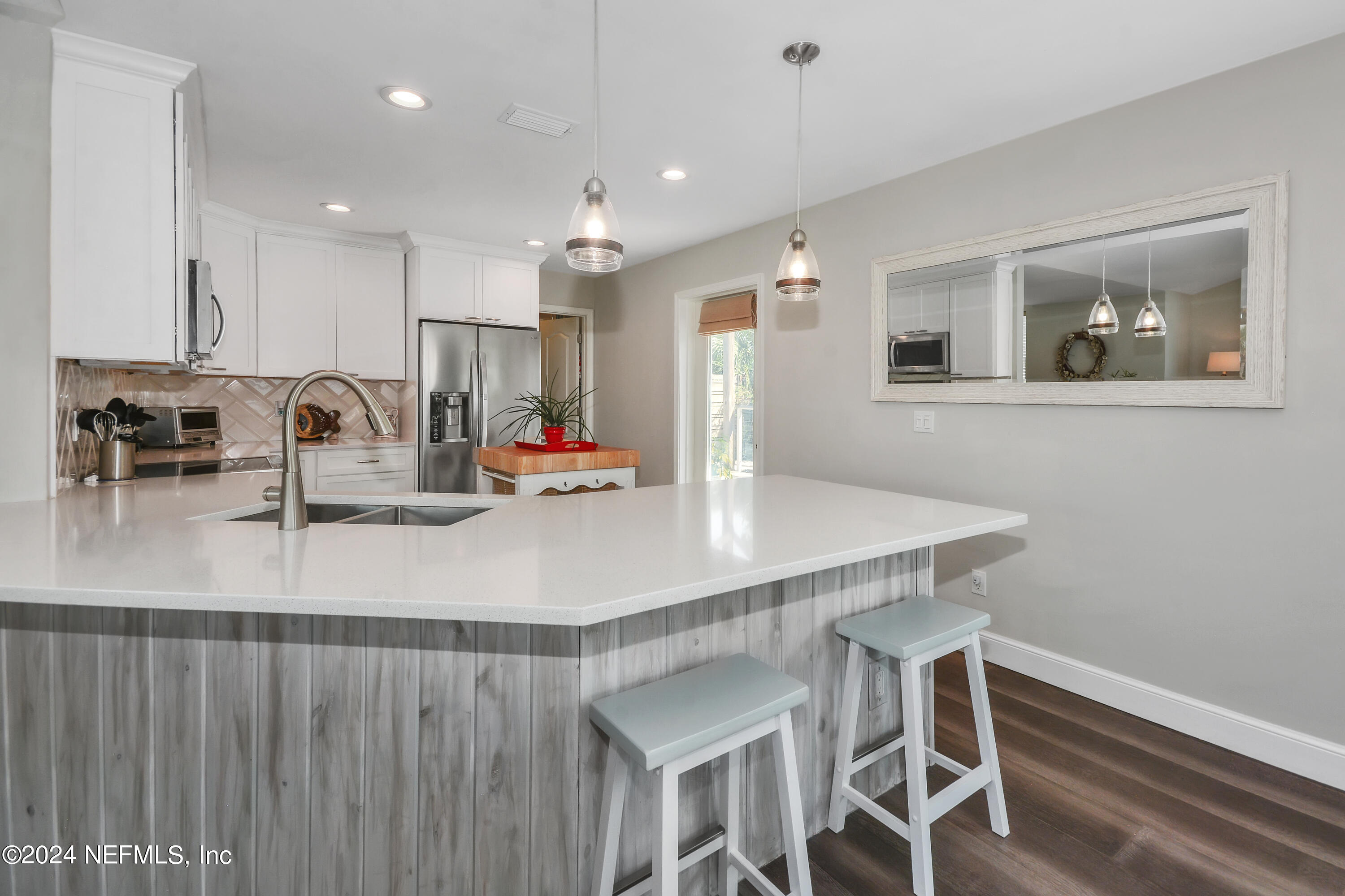 2740 Harbor Court St. Augustine, FL 32084 - Photo 11 of 53 a kitchen with kitchen island a sink table and chairs
