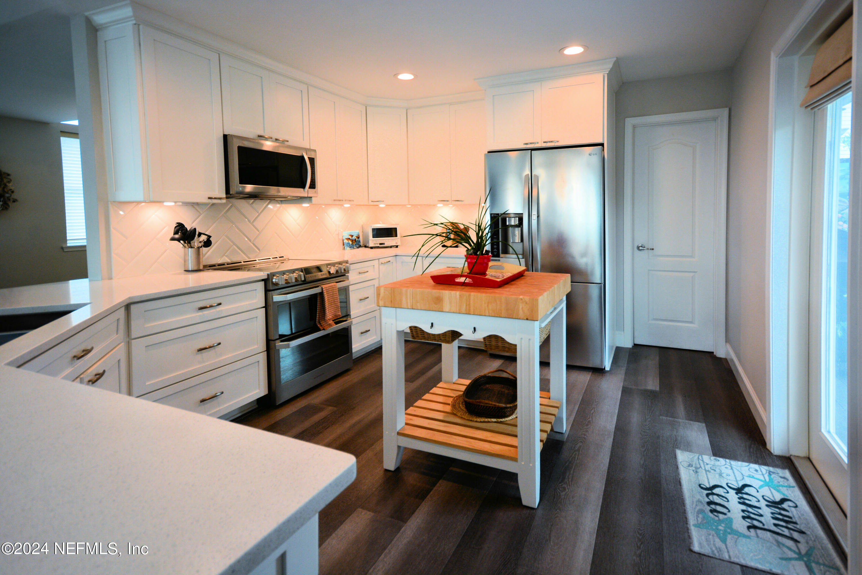 2740 Harbor Court St. Augustine, FL 32084 - Photo 14 of 53 a kitchen with stainless steel appliances a stove a sink a microwave and cabinets