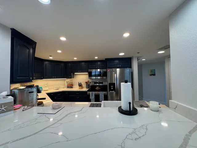 a spacious bedroom with a bed and a dresser next to a window