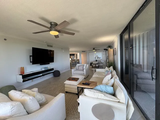 a living room with furniture a rug and white walls