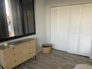 a living room with furniture a window and a flat screen tv
