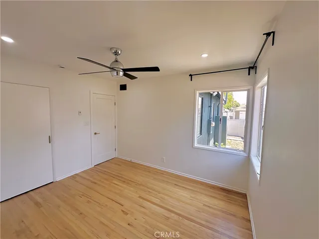 a view of a big room with a ceiling fan