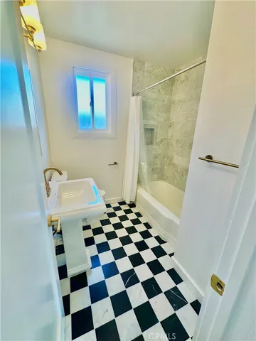 a bathroom with a bathtub and a shower