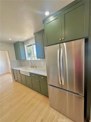 a kitchen with stainless steel appliances a refrigerator and a sink