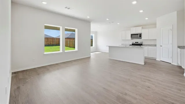 a view of kitchen with stainless steel appliances refrigerator oven and cabinets