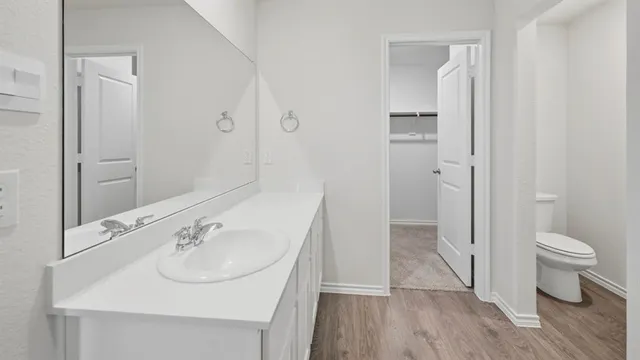 a bathroom with a sink toilet and a mirror