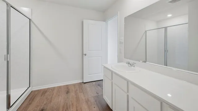 a bathroom with a sink and mirror