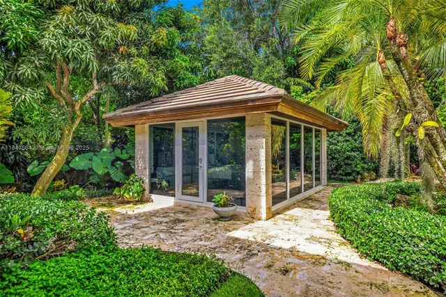 a front view of a house with a garden