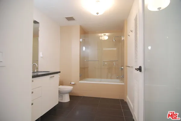 a bathroom with a glass door shower