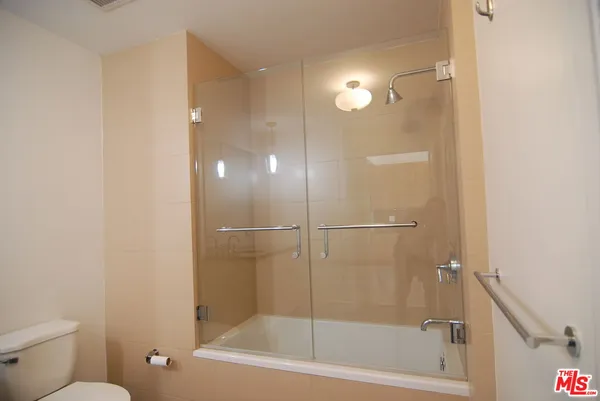 a bathroom with a shower a toilet and a shower