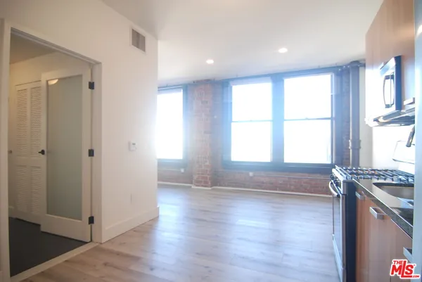 a view of kitchen with window and wooden floor