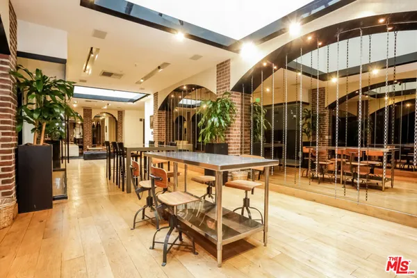 a patio with glass top table and chairs