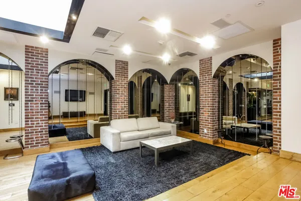 a living room with furniture chandelier and window