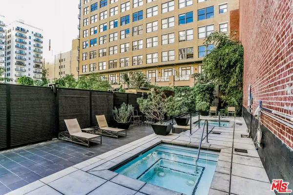 a view of a patio with a table and chairs and potted plants