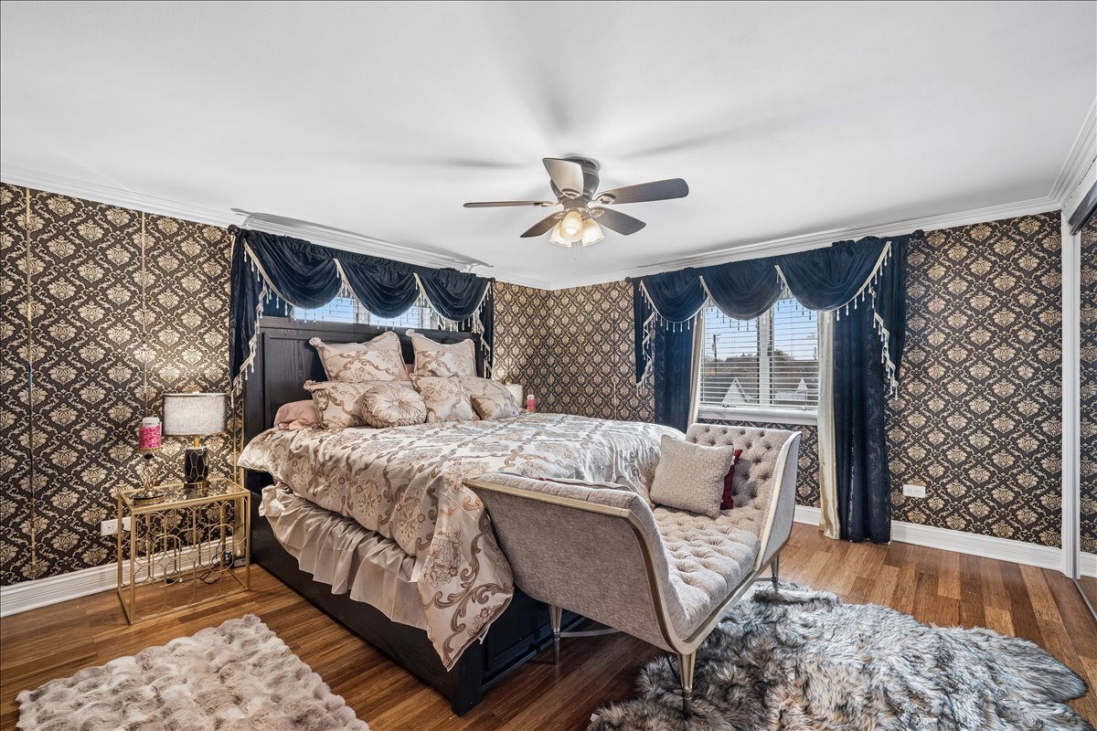 2455 North Rhodes Avenue River Grove, IL 60171 - Photo 11 of 24 a bed sitting in a bedroom next to a window with a chandelier and table