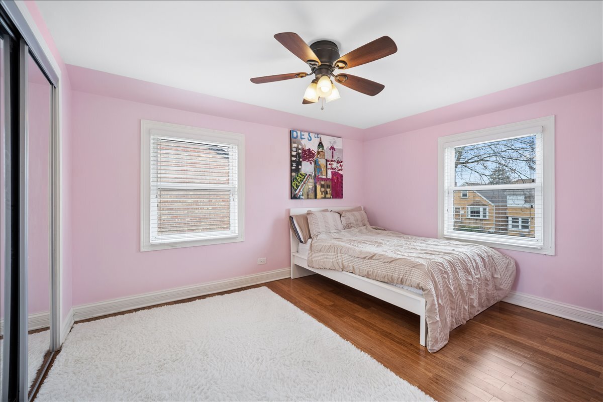 2455 North Rhodes Avenue River Grove, IL 60171 - Photo 12 of 24 a bedroom with a bed and a chandelier