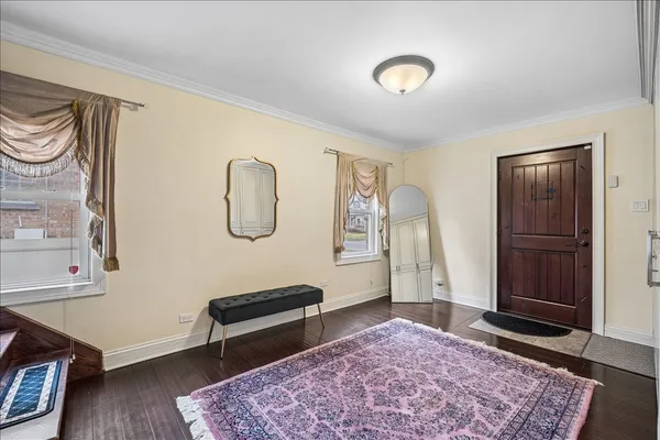 a bedroom with furniture and a rug
