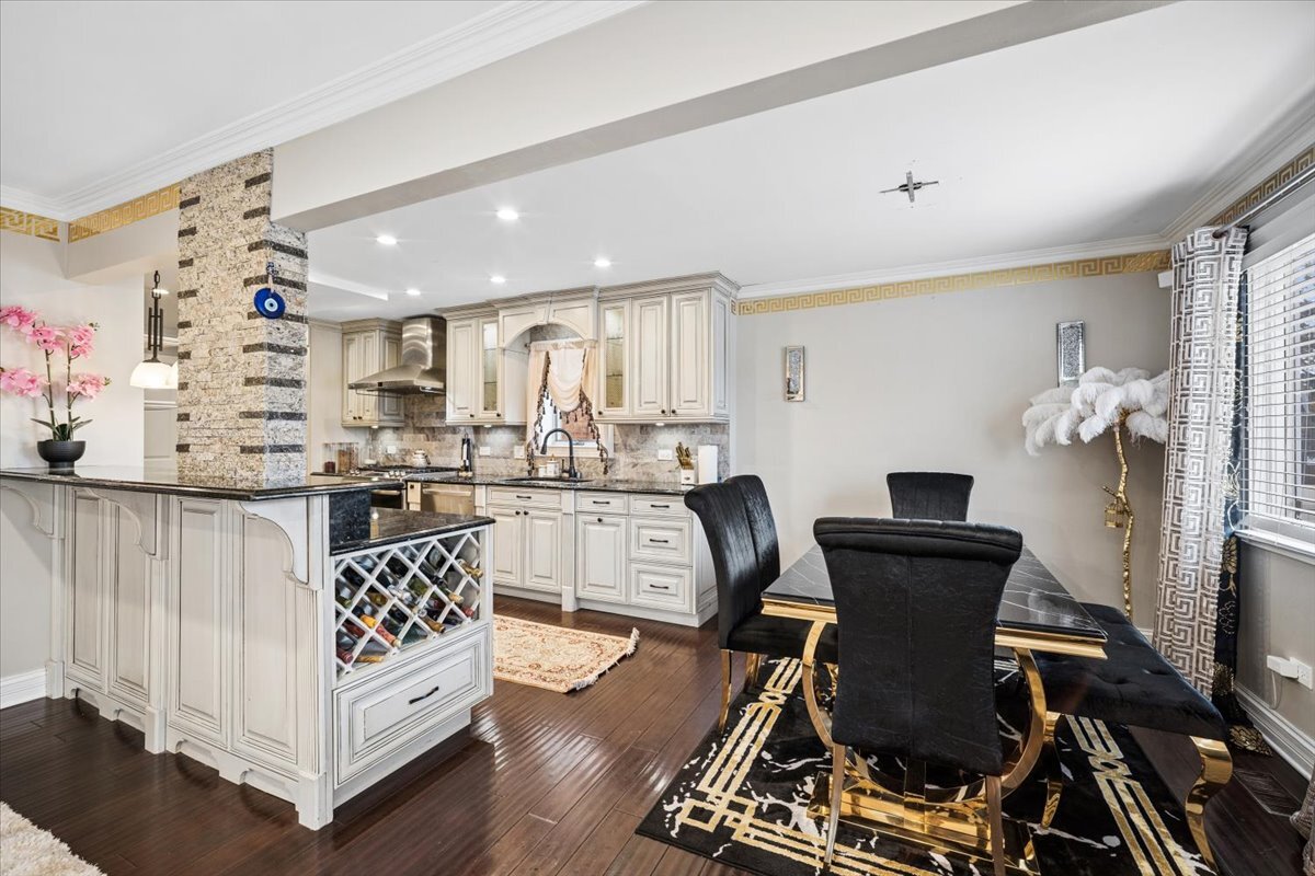 2455 North Rhodes Avenue River Grove, IL 60171 - Photo 8 of 24 a living room with furniture and a dining table with wooden floor