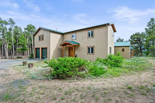a front view of house with yard and green space