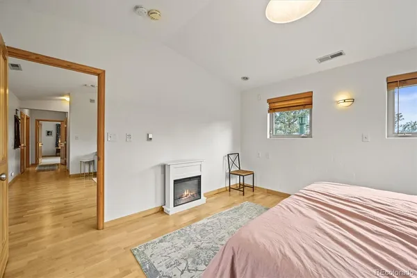 a bathroom with a granite countertop sink a mirror and shower