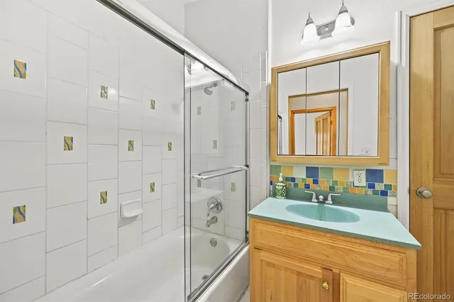a bathroom with a glass shower door