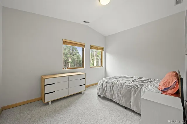 a front view of a house with garden and patio