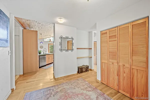 a view of a kitchen with refrigerator and windows
