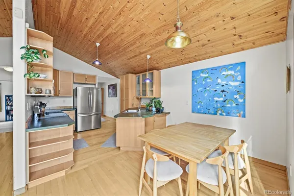 a view of a dining room with furniture a chandelier and wooden floor