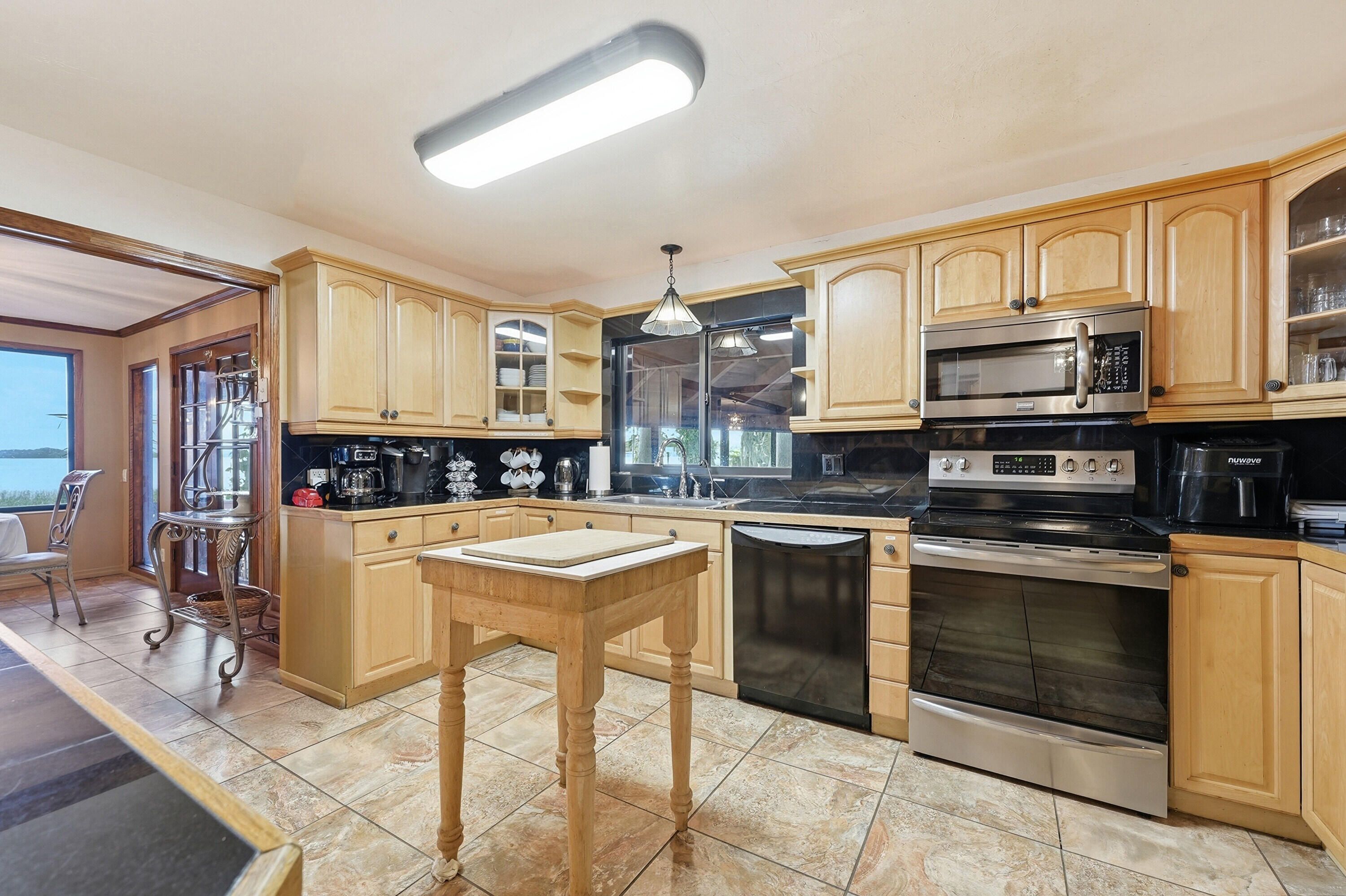 200 Windy Point Road Lake Placid, FL 33852 - Photo 7 of 74 a kitchen with stainless steel appliances granite countertop a stove and a sink