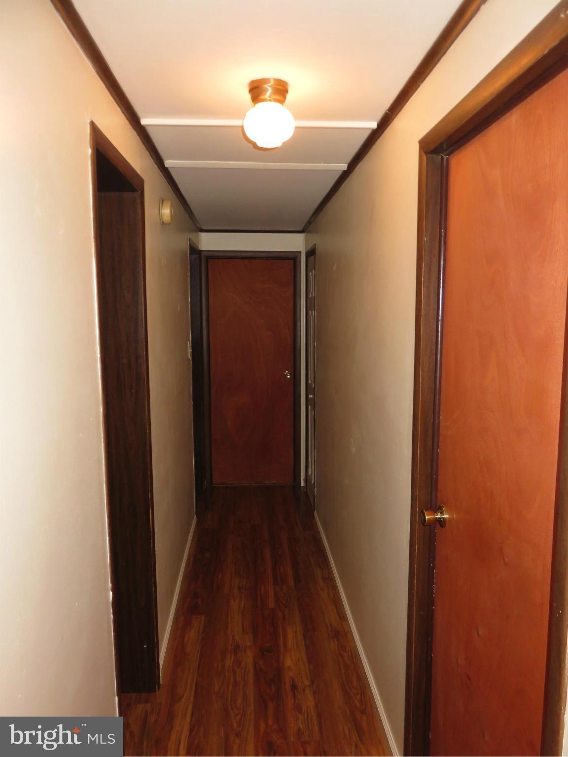 244 1st Street Inwood, WV 25428 - Photo 9 of 17 MAIN HALLWAY LAMINATE FLOOR