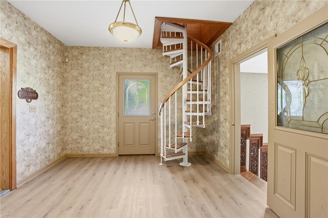 6271 Batman Road Zionsville, PA 18092 - Photo 33 of 100 A striking spiral staircase anchors this inviting entrance foyer.