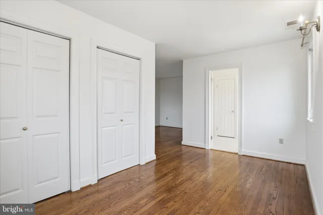an empty room with wooden floor
