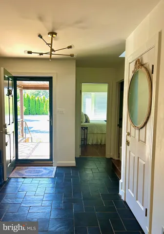 a bathroom with a granite countertop sink a mirror and a shower