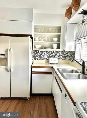 a kitchen with a refrigerator and a sink