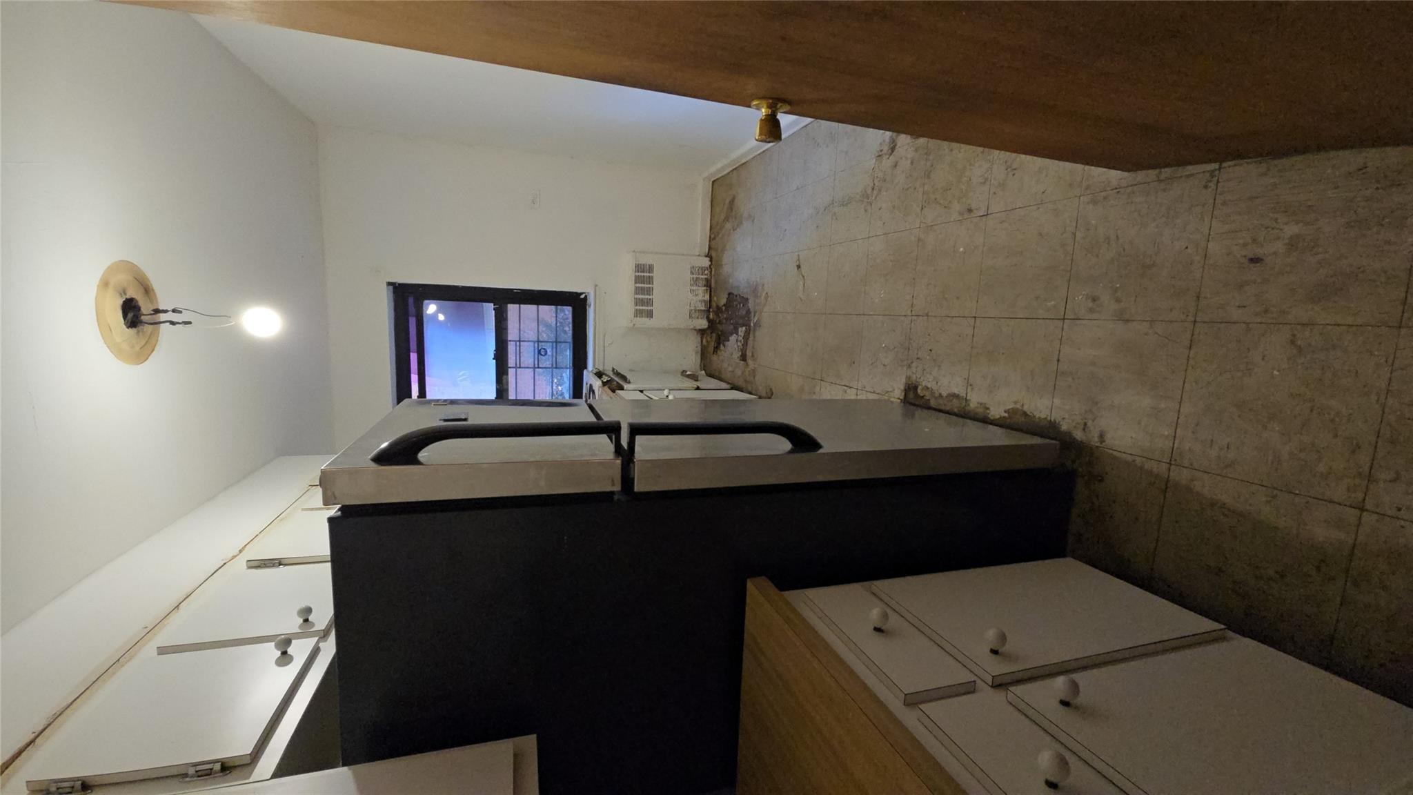 102-25 67th Road, Unit 1F Queens, NY 11375 - Photo 5 of 6 Kitchen featuring light tile patterned floors, radiator heating unit, fridge, and white cabinets